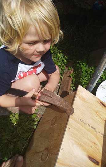 How to make a bug hotel-Kids hammering